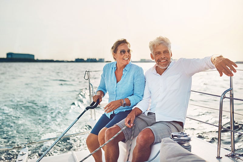 Middle aged man and woman smiling on a boat